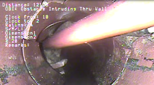 Utility line passing through sewer pipe wall